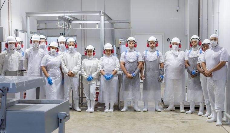 Equipe do frigorífico na sala de produção.